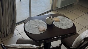 A balcony with a view of the ocean and a building across the street. - Coastal Tides Ocean View Studio (Daytona Beach)