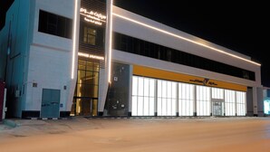 A modern building with a sign for 'Serviced Apartments' and a 'Dolphin' logo. - Celine Home Serviced apartment -Tuwaiq  (Riyadh)