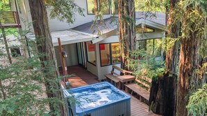 A hot tub on a wooden deck surrounded by trees. - LUX Private Modern Villa | Pool, Spa, & Dogs OK (Calistoga)