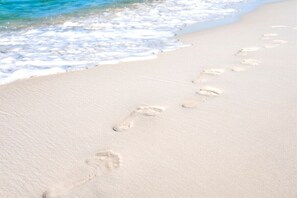 Footprints on a sandy beach with ocean waves in the background. - 30A | Rooftop Pool | Gulf Views | 2 Min To Beach! (Santa Rosa Beach)