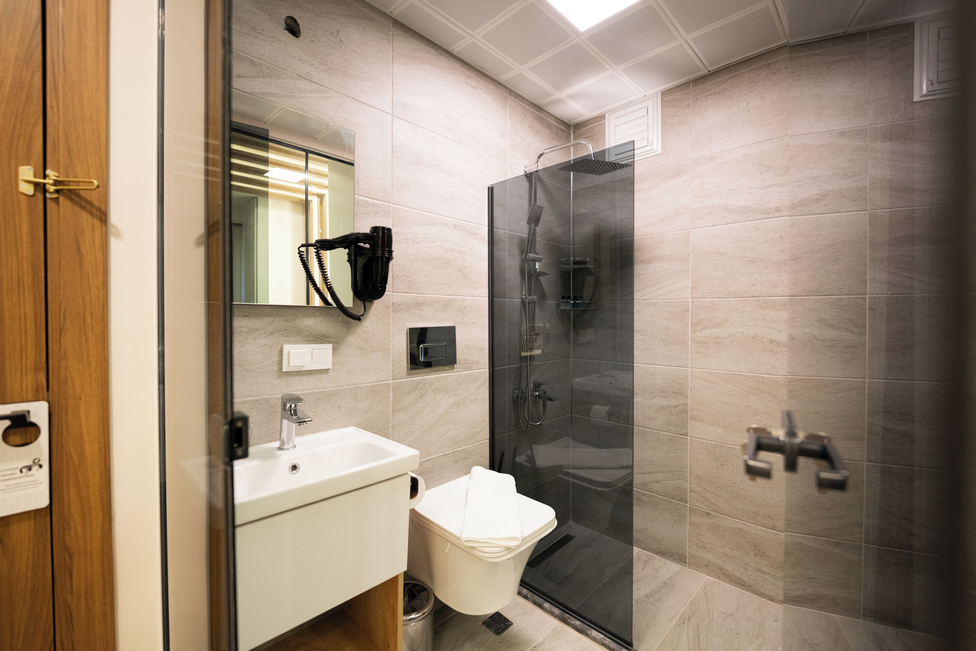 Shower, rainfall showerhead, hair dryer, towels
