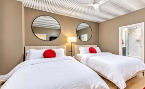 A hotel room with two beds, a ceiling fan, and a large window. - Chic Nash Home, 4bd/4ba w/ Hot Tub & Rooftop! (Nashville)
