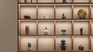 A modern interior with a wooden shelving unit displaying various decorative items. - Mixalakopoulou Luxury Apartment (Athens)