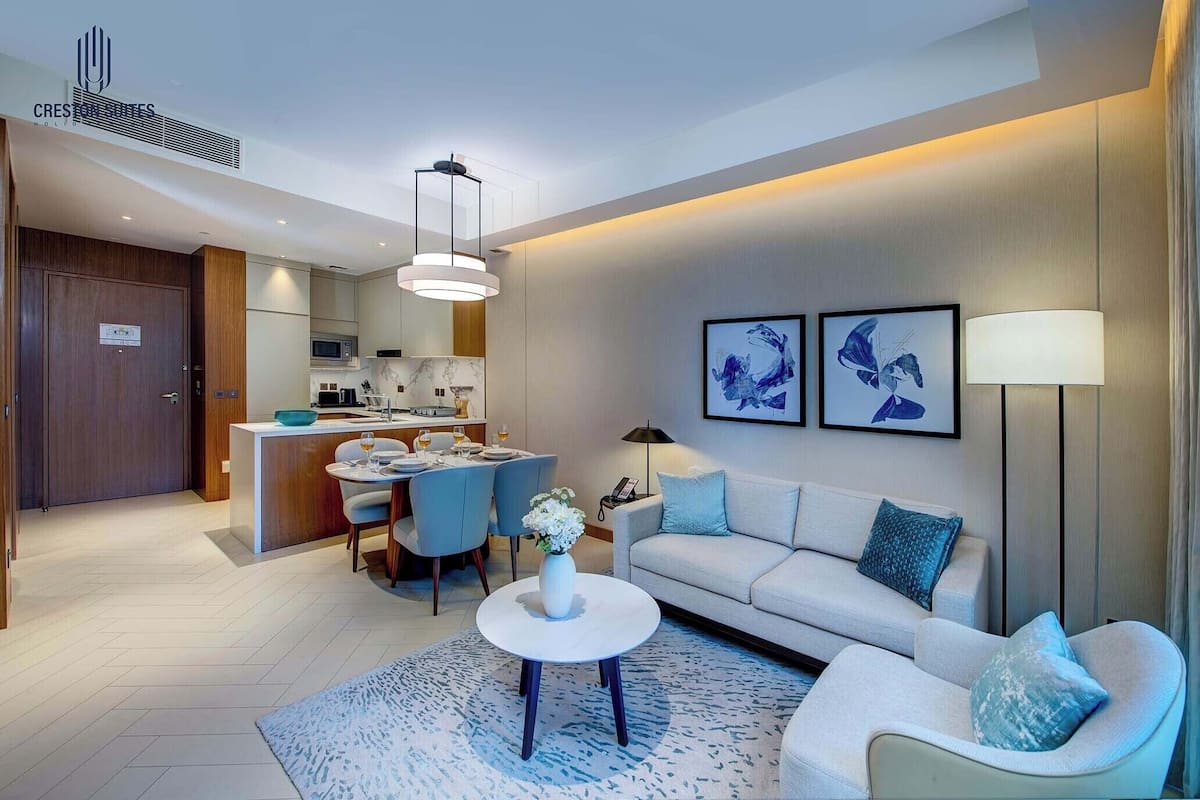 A modern living room with a sofa, coffee table, and artwork on the wall.