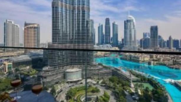A high-rise building with a view of a cityscape and a river. - Creston Suites Vacation Homes Rental - Address Opera Residences (Dubai)