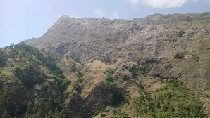 A mountainous landscape with rugged terrain and sparse vegetation. - Tirthan Villa Resort (Banjar)