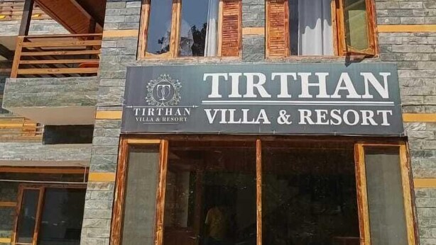 A multi-story building with a sign for 'Tirthan Villa & Resort'. - Tirthan Villa Resort (Banjar)