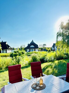 Enjoy a romantic dinner for two in our lush garden setting, complete with a beautifully set table and a glass of wine.