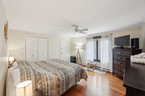 A bedroom with a bed, a desk, a chair, a dresser, a TV, and a ceiling fan. - Wood Lot 28C - Retreat Near Recreation Center 2 Bedroom Townhouse by The Summit at Gore Mountain (North Creek)