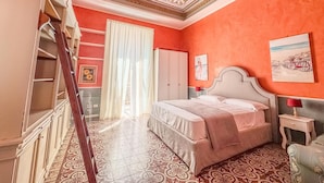 A bedroom with a bed, a wardrobe, a mirror, and a window with curtains. - YourHome - Chiara's Apartment Sorrento 3 (Piano di Sorrento)