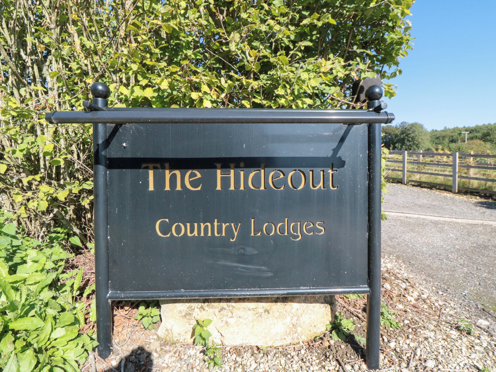 A sign for The Hideout Country Lodges.