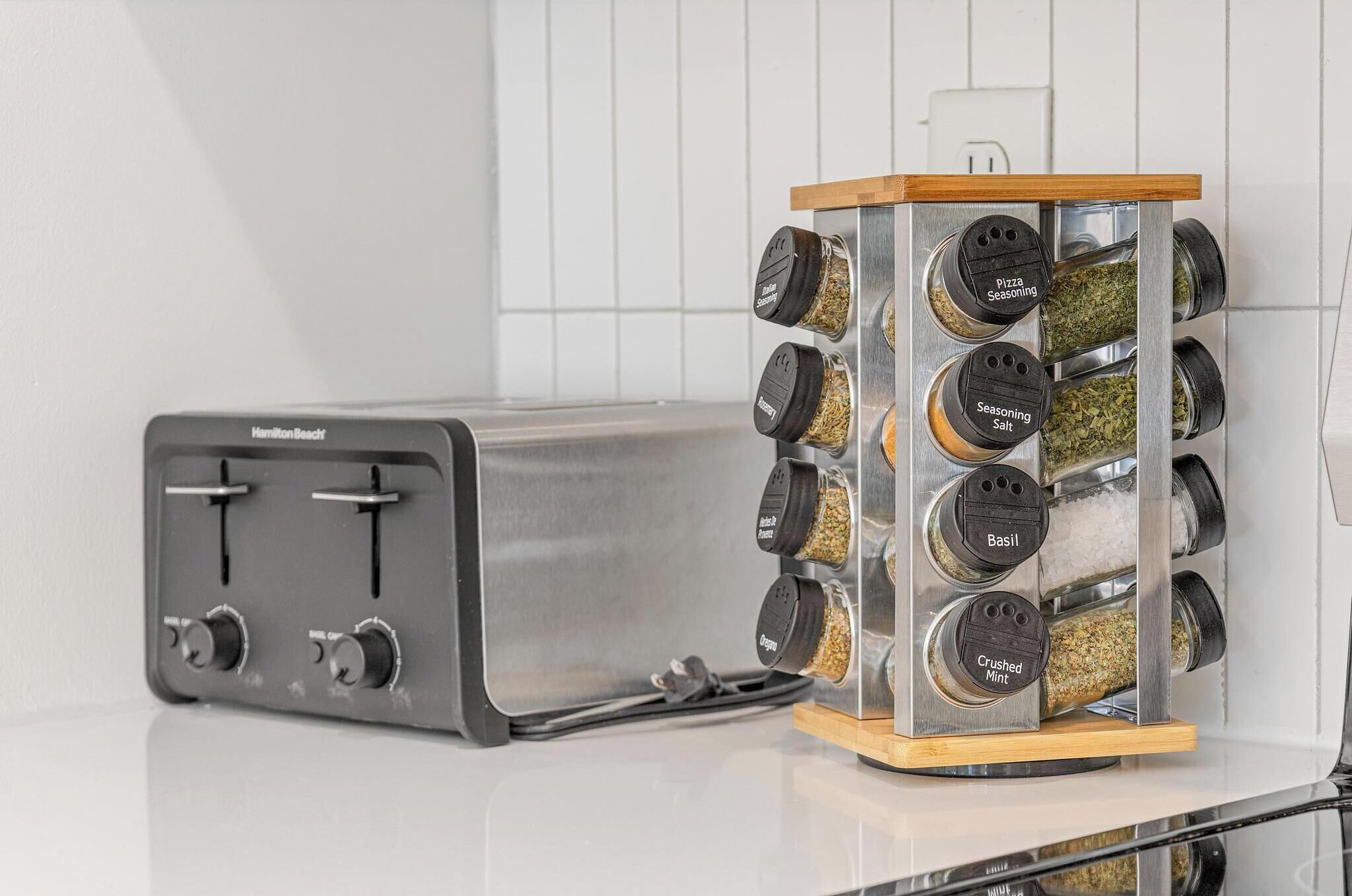 Modern kitchen counter with toaster and stocked spice rack