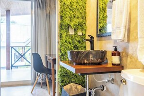 A bathroom with a marble sink, a green wall, a chair, and a view of the outdoors. - Kaloka Group-Friendly Beach Oasis, 12 Room Retreat (Jaco)