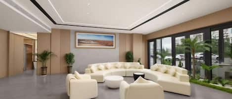 A modern lounge area with a curved sofa set, a coffee table, and potted plants.