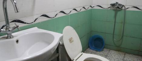 A bathroom with a sink, toilet, and shower.