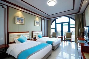 A hotel room with two beds, a balcony, and a TV. - Beidaihe Bei Hua Yuan Sea View Hotel (Beidaihe Biluo Tower) (Qinhuangdao)