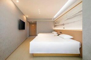 A hotel room with two beds, a flat-screen TV mounted on the wall, and a painting above the beds. - Yuelin Hotel (Fuzhou)