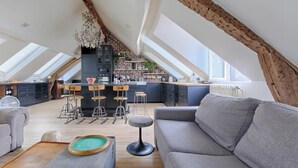 A spacious loft with a kitchen, dining area, and seating.
