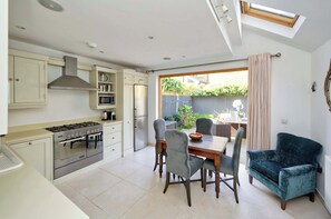 Enjoy cooking in the well-equipped kitchen with a gas stove, stainless steel appliances, and ample counter space.