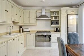 Enjoy cooking in this well-equipped kitchen with a stainless steel stove, oven, and microwave.