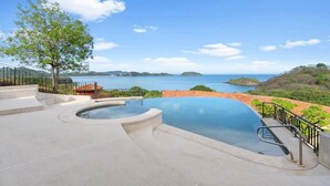 A infinity pool with a clear view of the sea and distant islands. - Stylish Villa with Brand-New Furniture, Panoramic Ocean Views, and Infinity Swimming Pool & Hot Tub (Potrero)