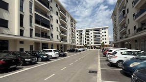 A multi-story parking garage with several cars parked in designated spaces.