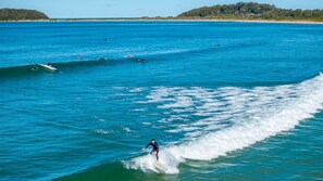 A beach with surfers and waves.