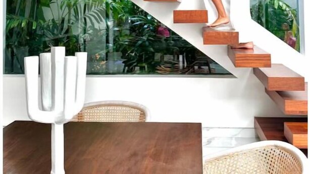 A woman in a white dress on a staircase with a view of tropical plants. - Luxury Villa Devina I Seminyak I Pool, Yoga & Gym (kerobokan Kelod)