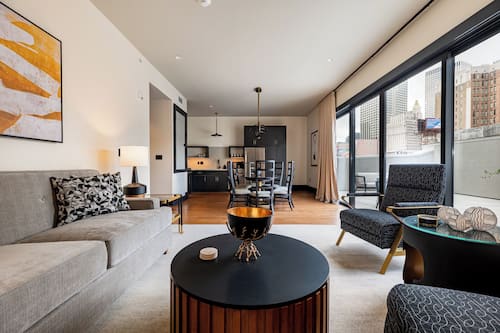 3BR Lavish Penthouse + Canal St Private Patio | The Mayfair | Living area | 65-inch Smart TV with cable channels, Netflix, Hulu
