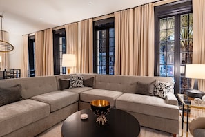 3BR City Views: Walk to French Qtr | The Mayfair | Living area | 65-inch Smart TV with cable channels, Netflix, Hulu