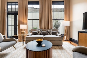 3BR Group Haven + Private Patio Walk to French Qtr | The Mayfair | Living area | 65-inch Smart TV with cable channels, Netflix, Hulu