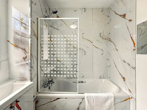 Combined shower/bathtub, deep-soaking bathtub, hair dryer, towels