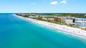 A coastal resort area with beachfront properties, including hotels and apartments, and a sandy beach. - Bayshore Yacht & Tennis 806 (Indian Shores)