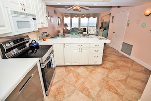 Enjoy ocean views from the kitchen, where a central island and stainless steel stove make cooking a breeze.