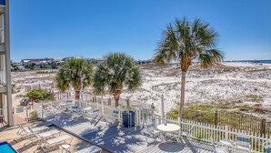 A beachside deck with lounge chairs and a pool, overlooking a sandy beach and ocean. - Coastal Paradise on Holiday Isle - Quiet place, snorkeling cove! Gated Parking! (Destin)