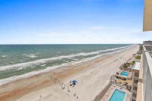 A beachfront hotel with a pool, beach access, and ocean views.