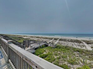 A beach view with wooden walkways and a sandy beach. - Twin Palms by Topsail Realty (Holly Ridge)