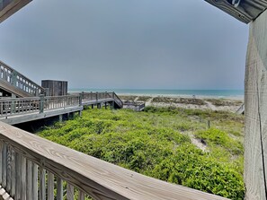A wooden boardwalk leading to a beach with a view of the ocean. - Twin Palms by Topsail Realty (Holly Ridge)