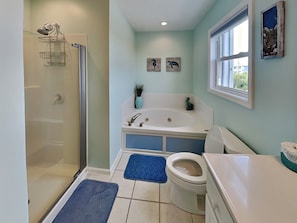 A bathroom with a walk-in shower, a bathtub, a toilet, and a sink.