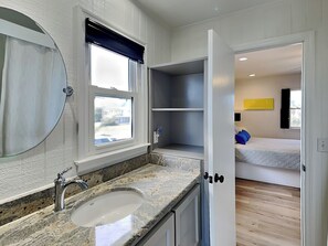 Enjoy a serene bathroom retreat with a single sink and a window offering a view.