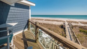 A balcony with a view of a beach and ocean. - Beach Coma by Topsail Realty (Holly Ridge)