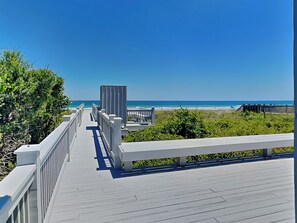 A wooden boardwalk leading to a beach with a clear view of the ocean. - A Beach Pearle by Topsail Realty (Holly Ridge)