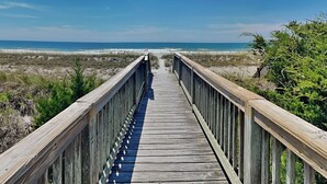 A wooden boardwalk leading to a beach with a clear view of the ocean. - Oceans 111 by Topsail Realty (Holly Ridge)