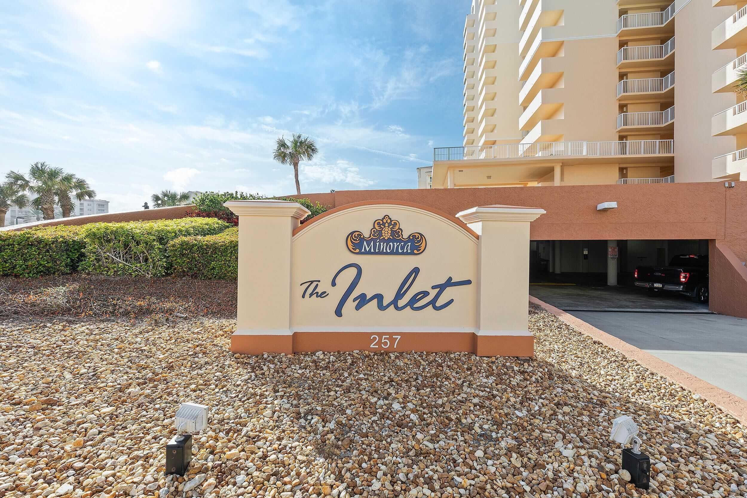 A hotel entrance with a sign reading "The Inlet 257" and a building in the background.