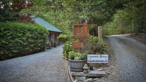 A gravel driveway leading to a rustic cabin labeled 'Summit House' with a website address. - Summit House, Ellijay, Ga (Ellijay)