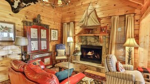 A cozy log cabin interior with a fireplace, leather furniture, and rustic decor. - Summit House, Ellijay, Ga (Ellijay)