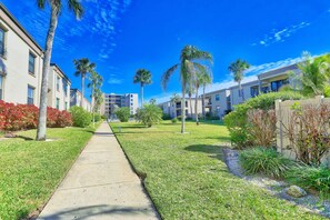 Residents enjoy a stroll through the beautifully maintained gardens and manicured lawns.