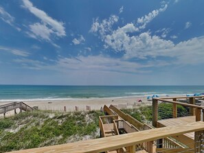 A beach with wooden walkways and a clear view of the ocean. - The Salty Spot by Topsail Realty (Holly Ridge)