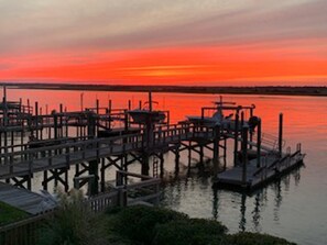 A waterfront dock with multiple piers and a calm body of water reflecting the sky.