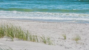 A beach with clear blue water and white sand. - Sea Ya Beaches by Topsail Realty (Holly Ridge)